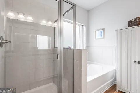 a bathroom with a bathtub and a shower