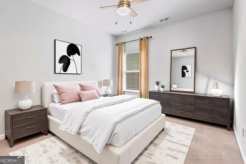 a large bed sitting in a bedroom and a dresser