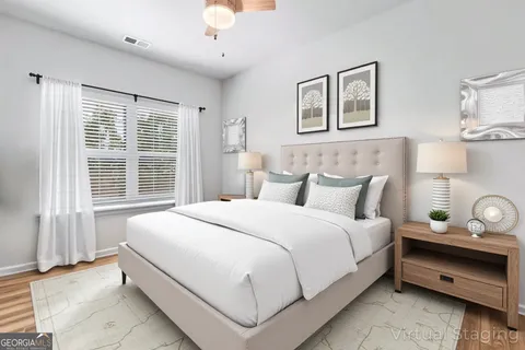 a bedroom with bed and a large window