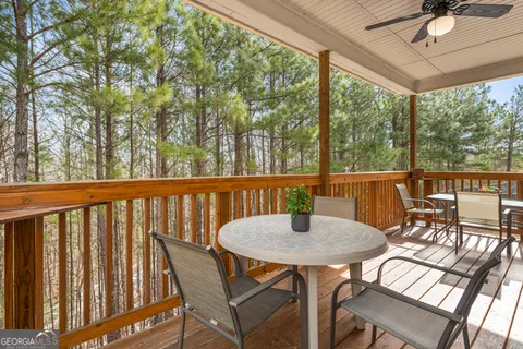 a view of a balcony with table and chairs