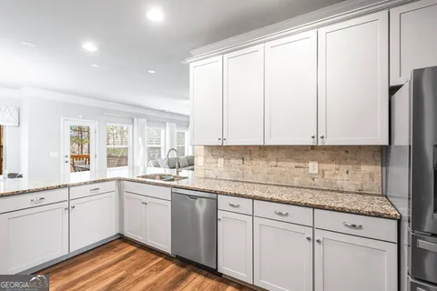 a kitchen with a sink window and cabinets