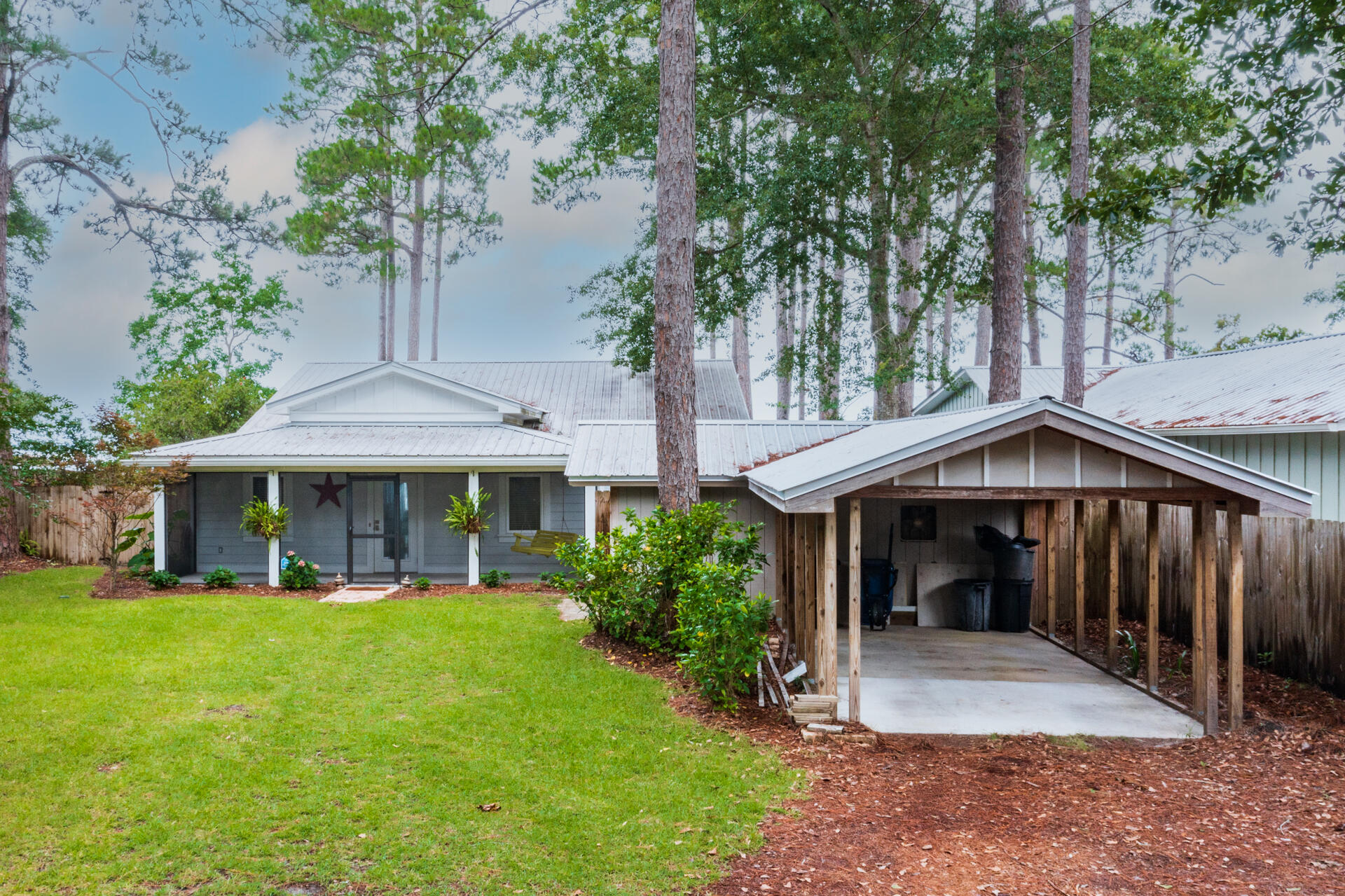 2336 Bay Grove Road Freeport, FL 32439 - Photo 3 of 22 a front view of a house with garden