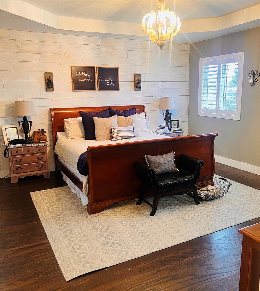 12780 Southwest 224th Street Miami, FL 33170 - Photo 11 of 29 a bed room with a bed and a chandelier