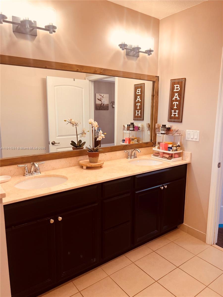 12780 Southwest 224th Street Miami, FL 33170 - Photo 12 of 29 a bathroom with a double vanity sink and a mirror