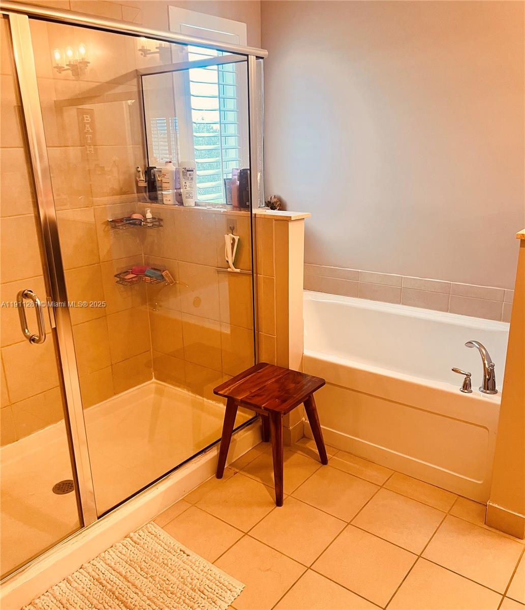 12780 Southwest 224th Street Miami, FL 33170 - Photo 13 of 29 a bathroom with a bathtub and a shower