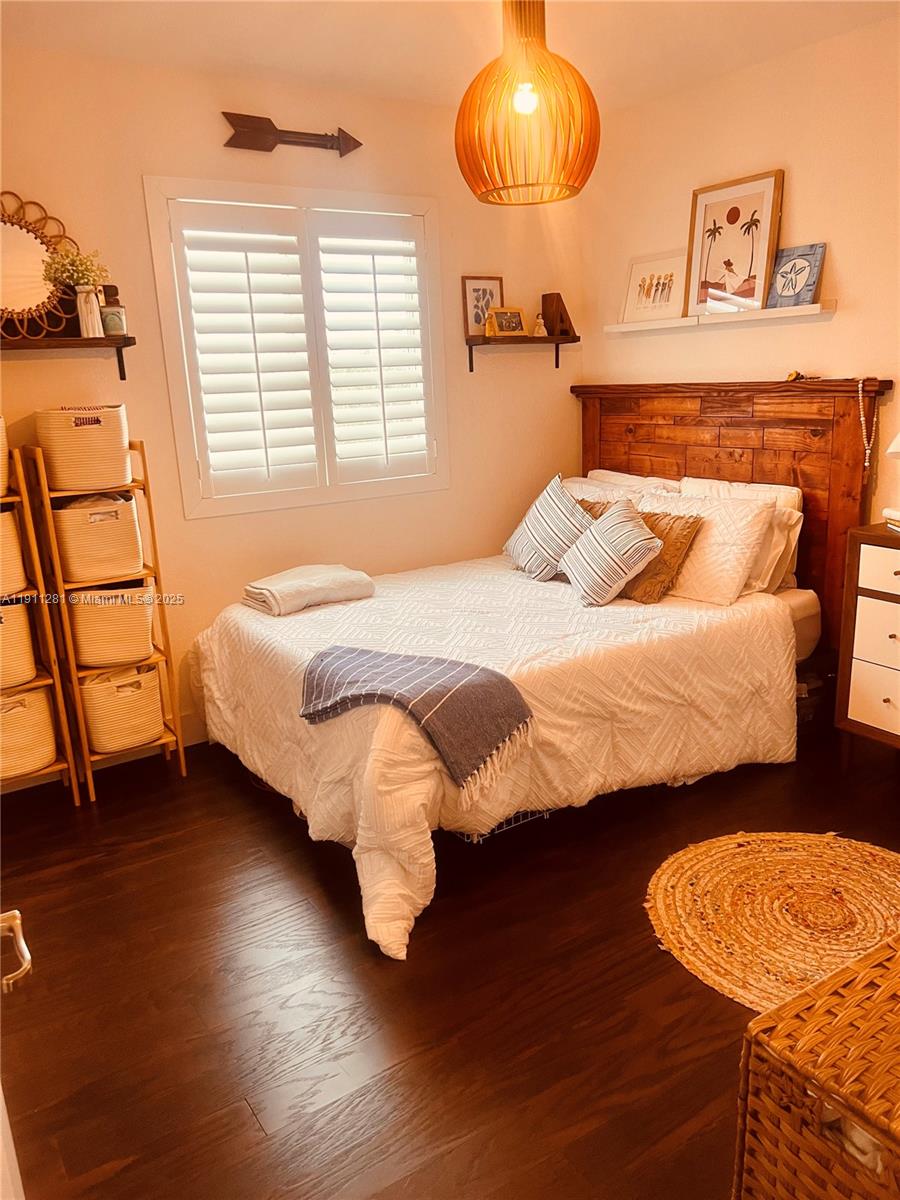 12780 Southwest 224th Street Miami, FL 33170 - Photo 15 of 29 a bedroom with a bed and wooden floor