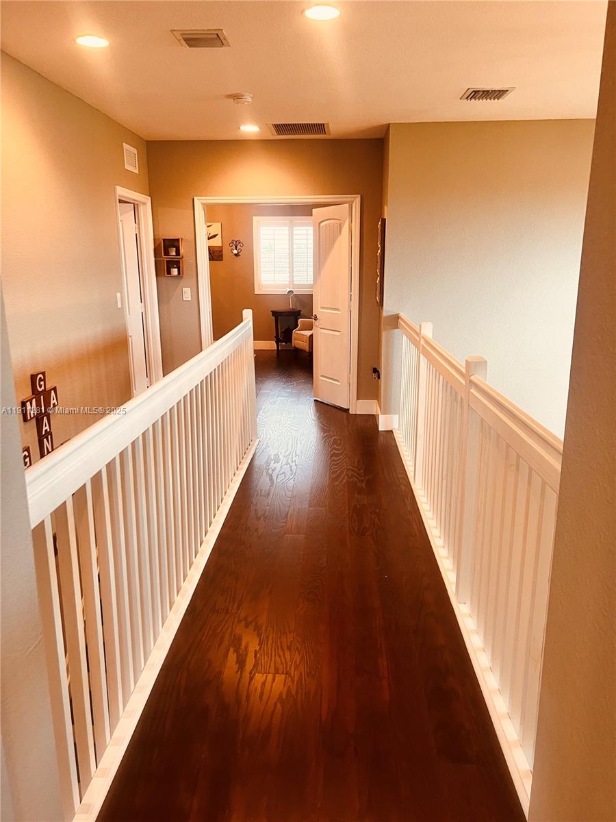 12780 Southwest 224th Street Miami, FL 33170 - Photo 18 of 29 a view of a hallway with wooden floor and stairs