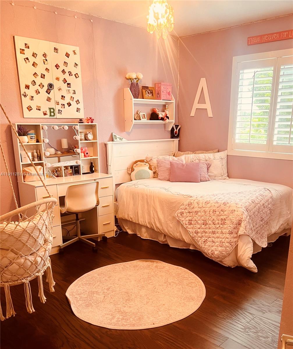 12780 Southwest 224th Street Miami, FL 33170 - Photo 19 of 29 a bedroom with two beds and a wooden floor