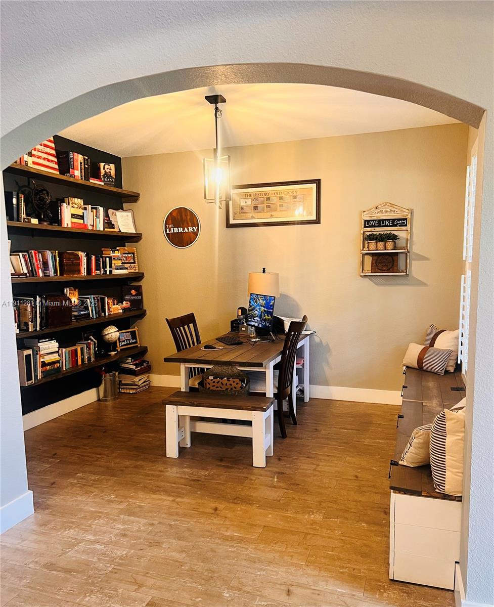 12780 Southwest 224th Street Miami, FL 33170 - Photo 20 of 29 a living room with furniture a rug and a bookshelf