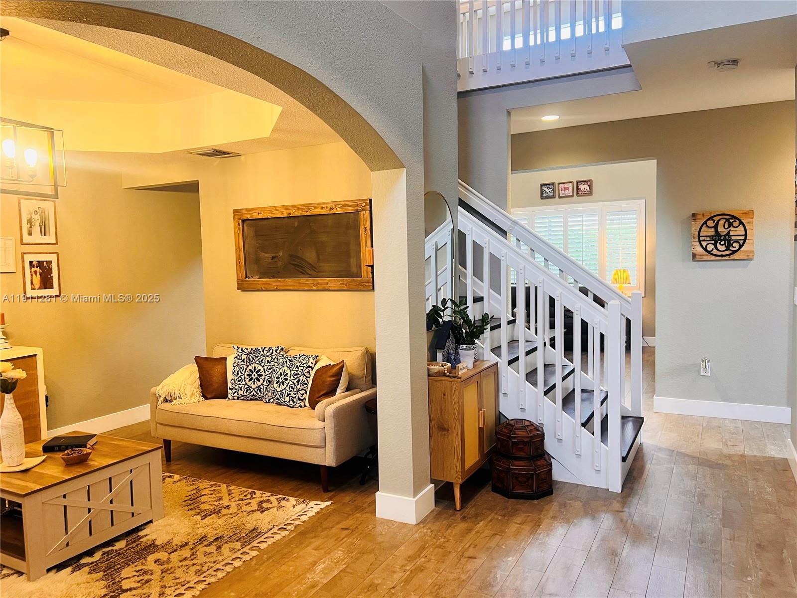 12780 Southwest 224th Street Miami, FL 33170 - Photo 2 of 29 a living room with furniture and a floor to ceiling window