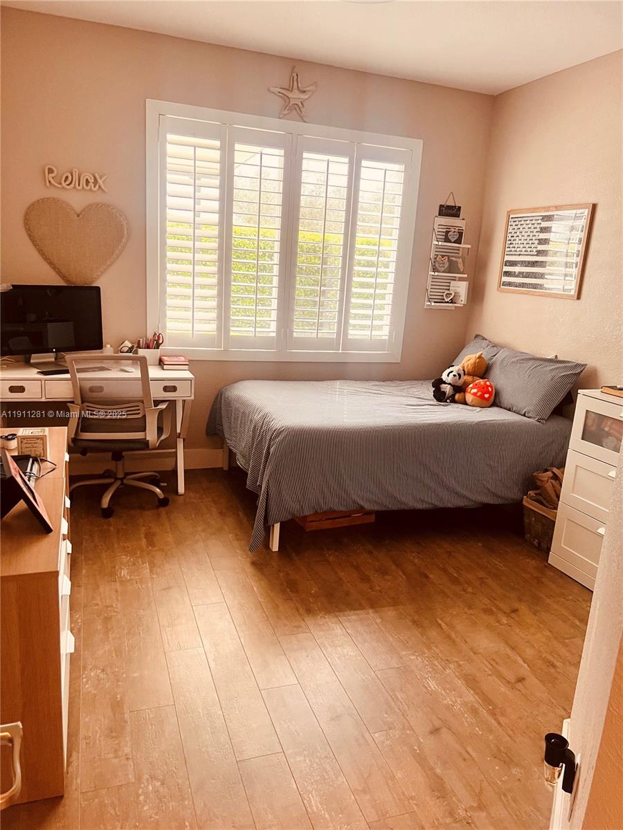 12780 Southwest 224th Street Miami, FL 33170 - Photo 22 of 29 a bedroom with a bed and a window
