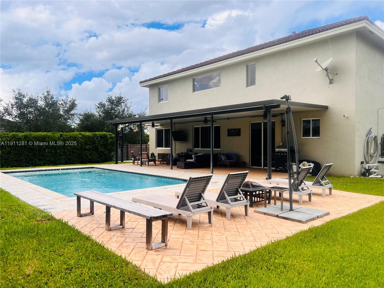 12780 Southwest 224th Street Miami, FL 33170 - Photo 26 of 29 a view of a house with swimming pool and sitting area