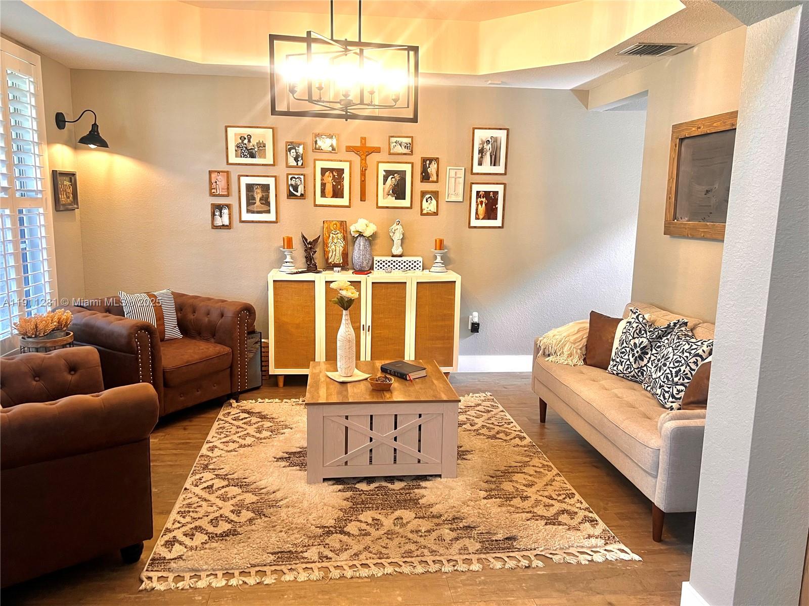 12780 Southwest 224th Street Miami, FL 33170 - Photo 3 of 29 a living room with furniture and painting on the wall