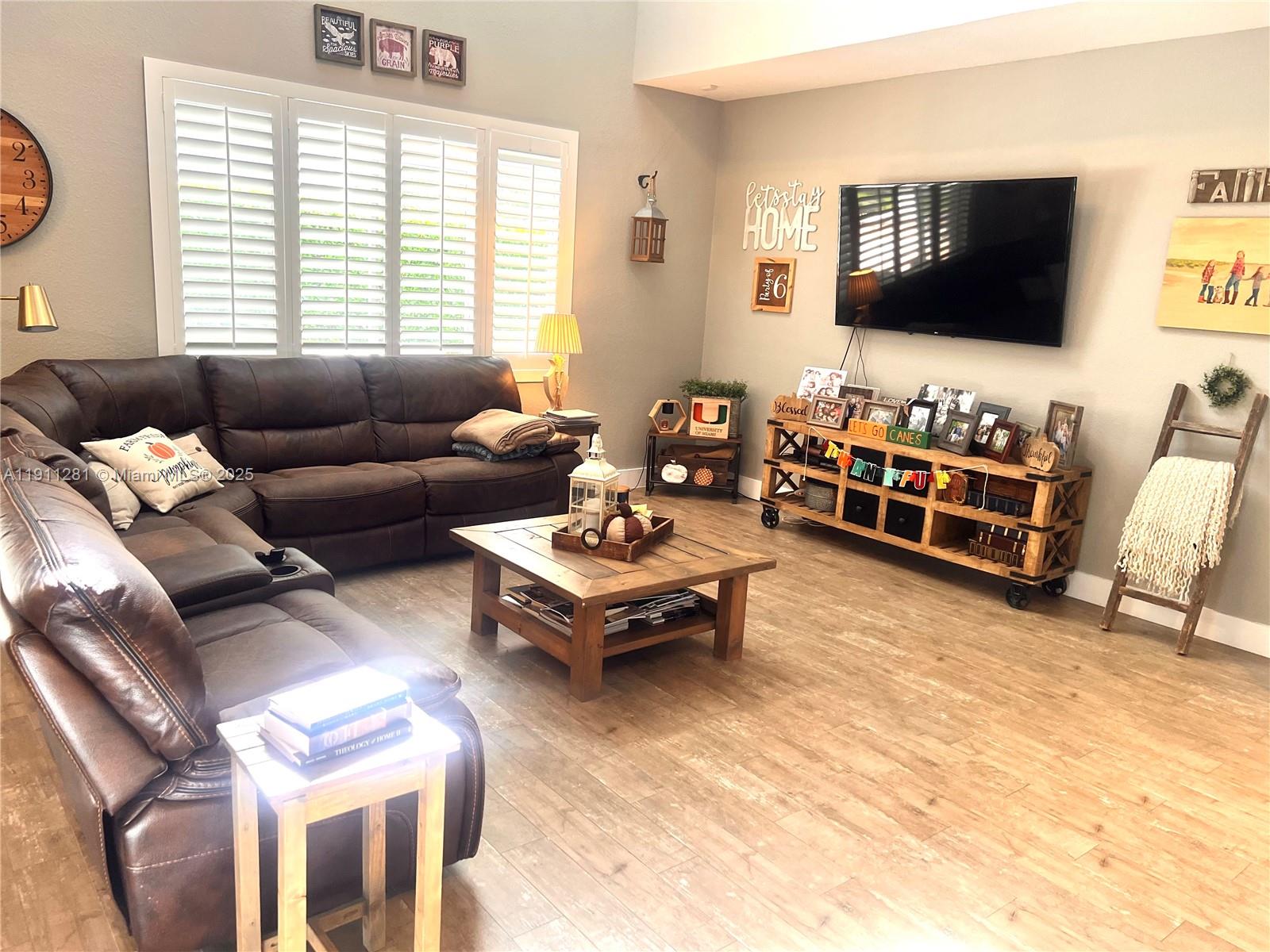 12780 Southwest 224th Street Miami, FL 33170 - Photo 10 of 29 a living room with furniture and a flat screen tv