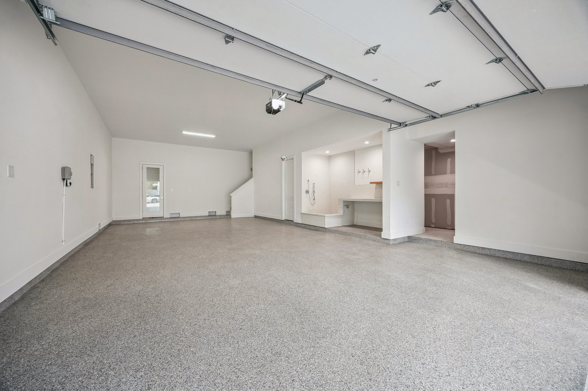 4034 Lanark Lane Houston, TX 77025 - Photo 29 of 32 Incredible Four Car Garage with an Epoxy Treated Floor, plus extra storage and access to the elevator shaft. The Garage is also Pre-Wired for Two 220V Outlets.