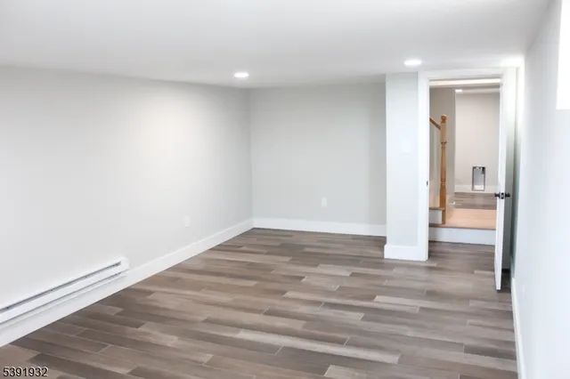 a view of wooden floor and windows in a room