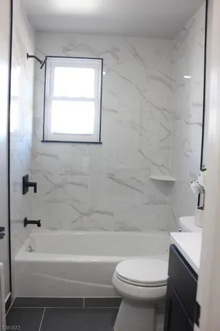 a bathroom with a toilet a sink and bathtub