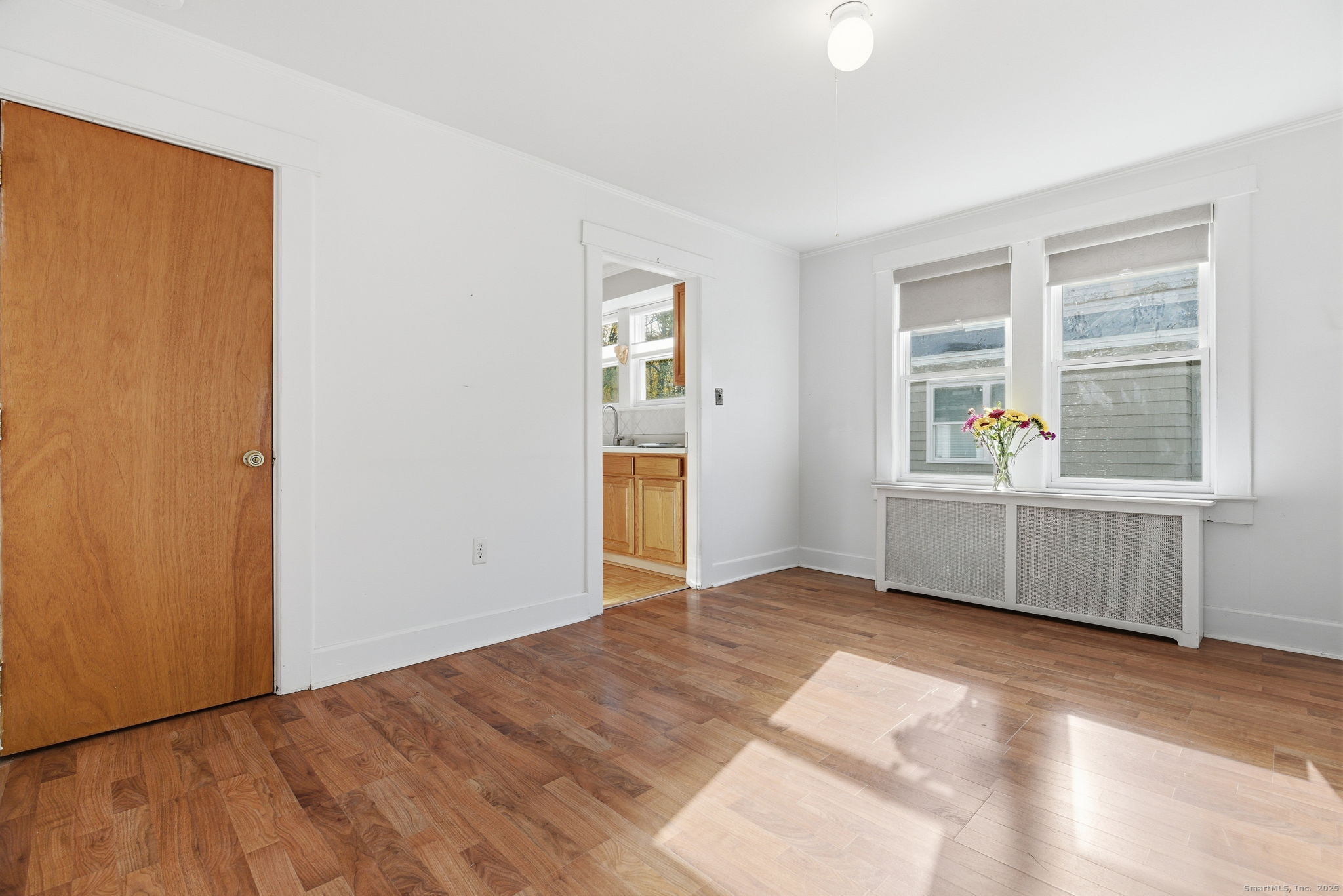 41 Sterling Place, Unit 1 Stamford, CT 06907 - Photo 7 of 29 a view of an empty room with a window and wooden floor