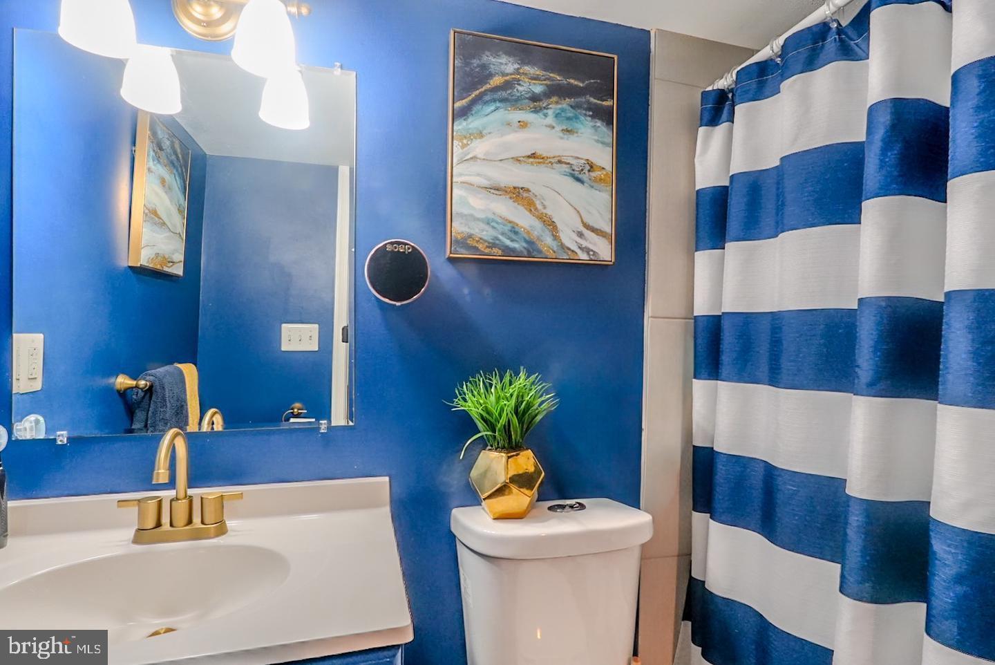 3915 Flowerton Road Baltimore, MD 21229 - Photo 15 of 15 a bathroom with a sink mirror and vanity