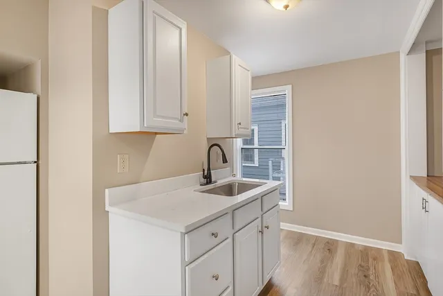 a kitchen with a sink and cabinets