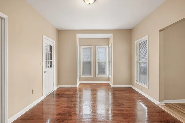a view of an empty room and wooden floor