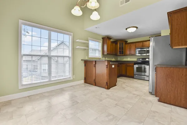 a view of kitchen with window and stainless steel appliances