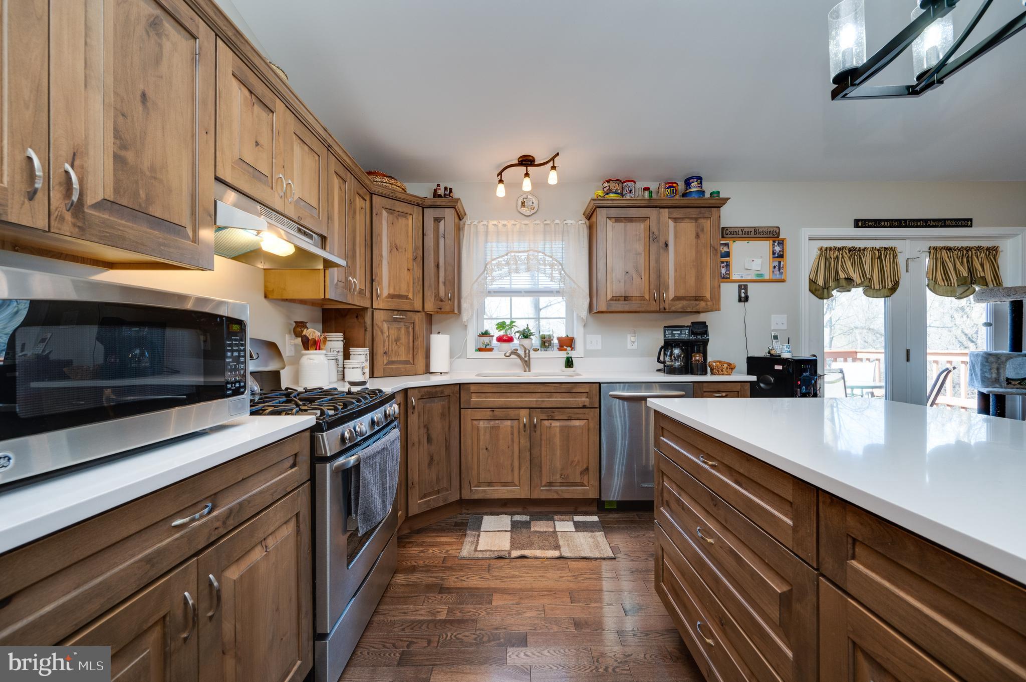 1133 Ashbourne Drive Reading, PA 19605 - Photo 16 of 64 a kitchen with stainless steel appliances granite countertop a sink stove and microwave