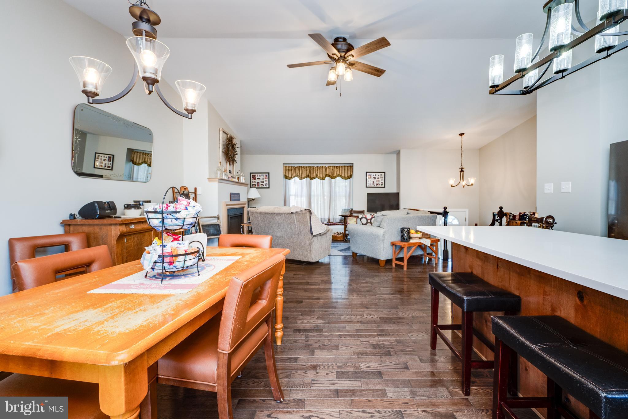 1133 Ashbourne Drive Reading, PA 19605 - Photo 19 of 64 a dining room with wooden floor a chandelier a wooden table and chairs
