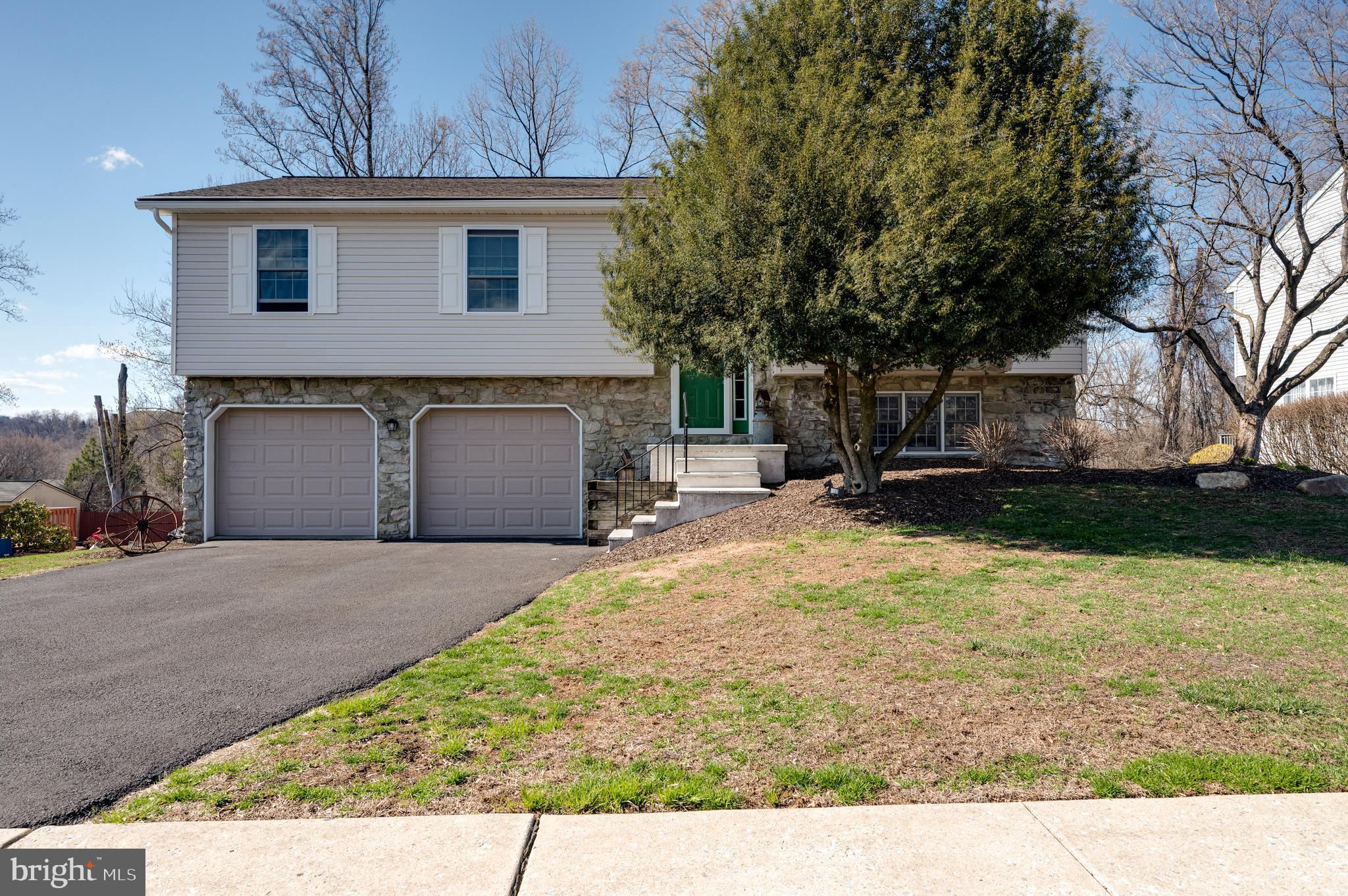 1133 Ashbourne Drive Reading, PA 19605 - Photo 2 of 64 a front view of a house with a yard and garage