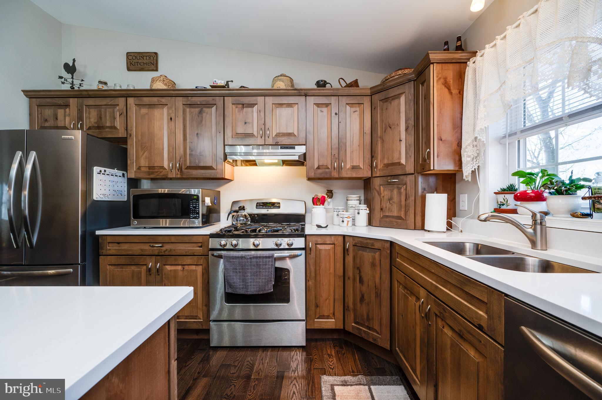 1133 Ashbourne Drive Reading, PA 19605 - Photo 21 of 64 a kitchen with stainless steel appliances granite countertop a sink stove and refrigerator