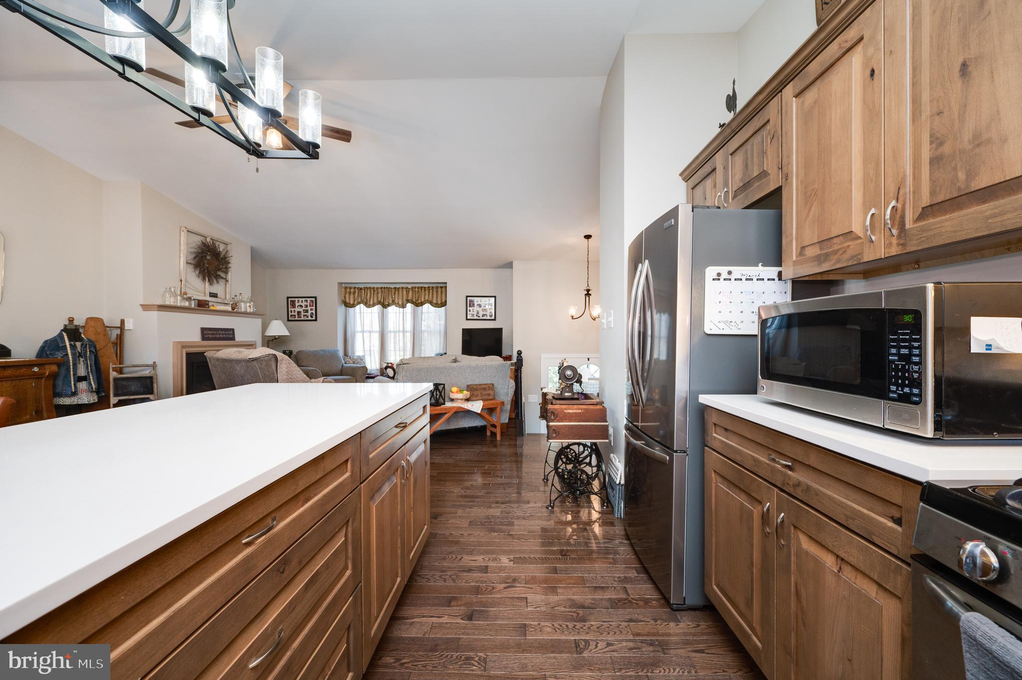 1133 Ashbourne Drive Reading, PA 19605 - Photo 22 of 64 a kitchen with stainless steel appliances a sink dishwasher a oven a microwave oven with cabinets and wooden floor