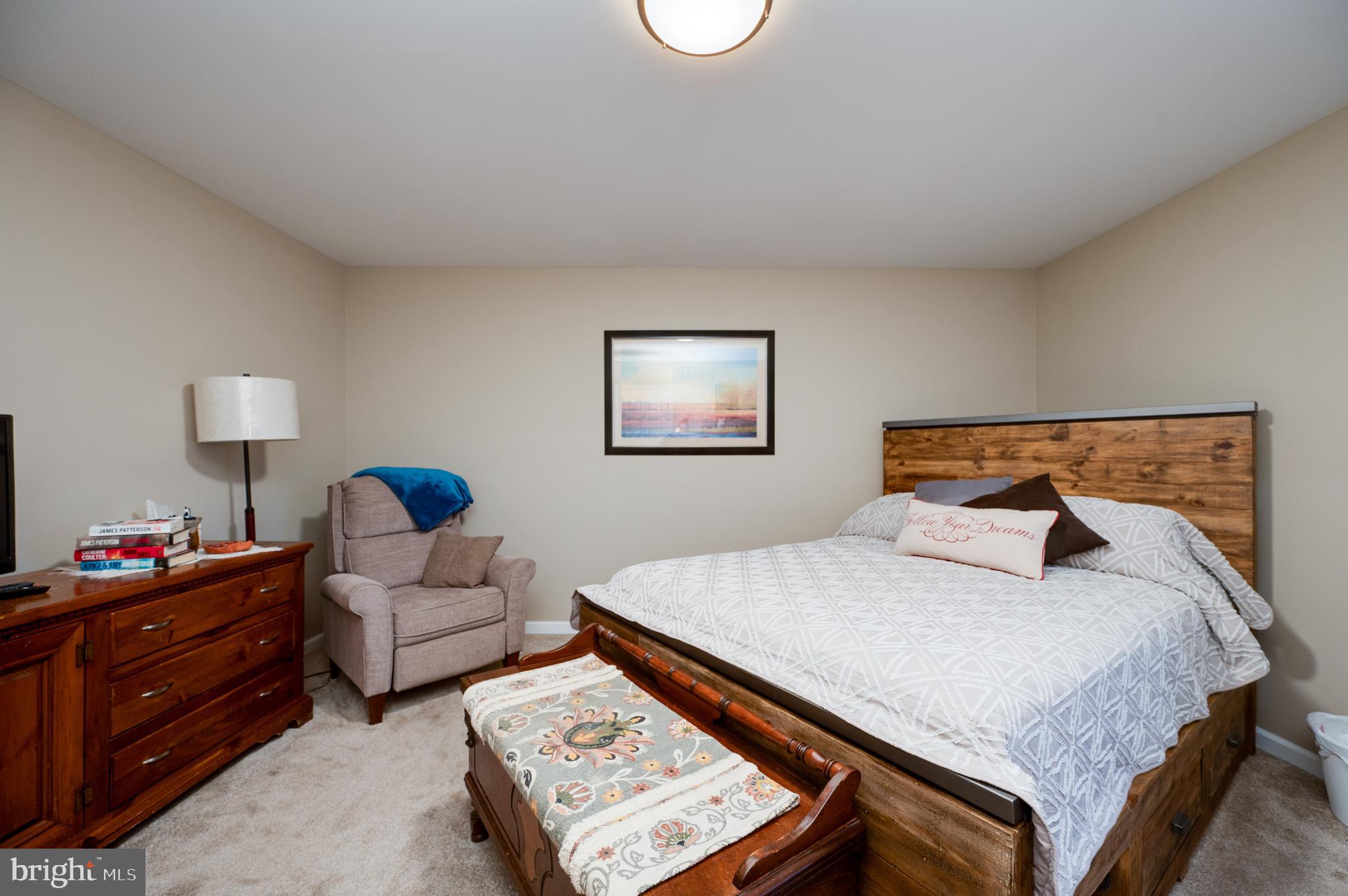 1133 Ashbourne Drive Reading, PA 19605 - Photo 34 of 64 a bedroom with a bed and a lamp on dresser