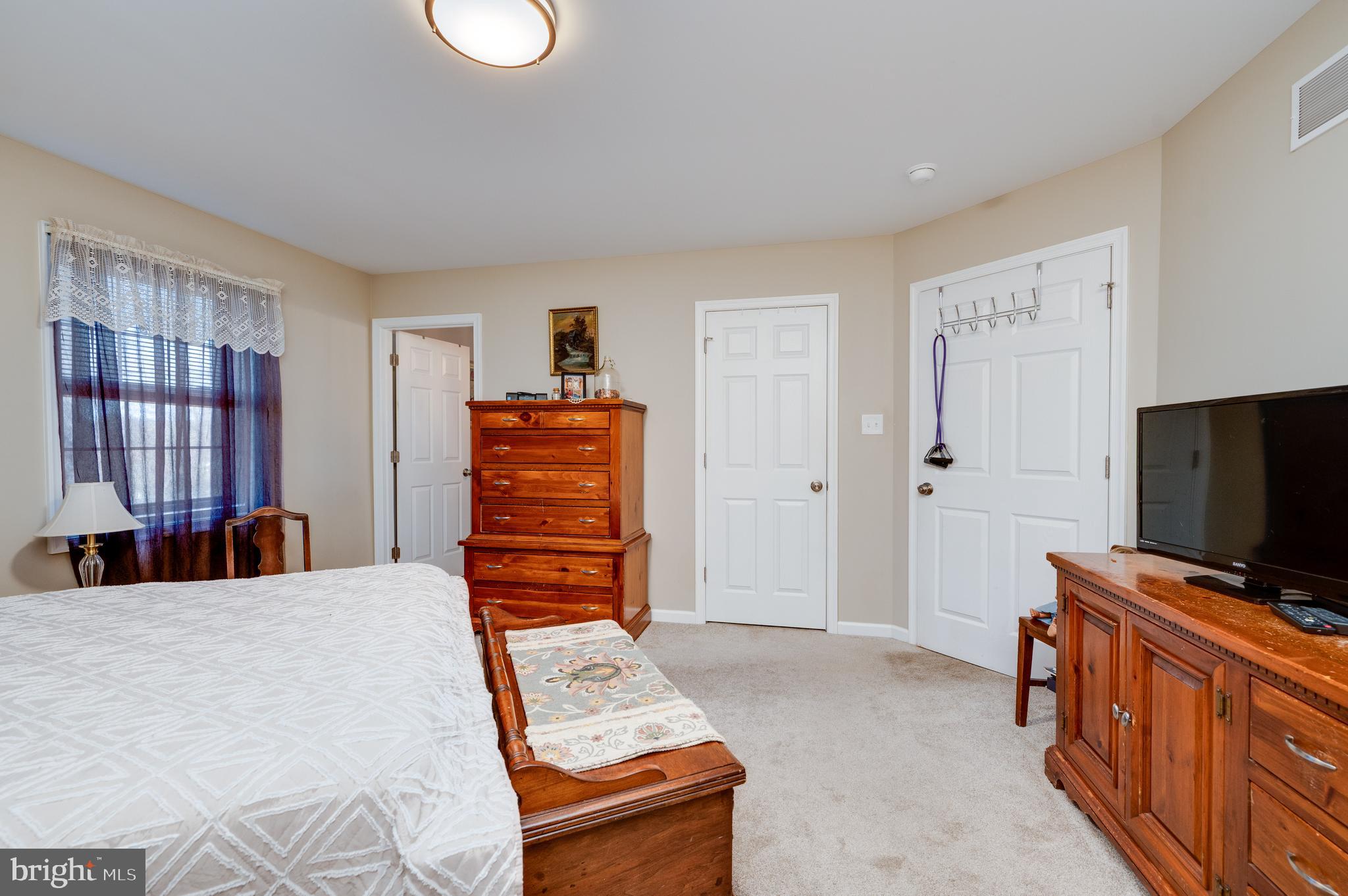 1133 Ashbourne Drive Reading, PA 19605 - Photo 36 of 64 a bedroom with a bed and flat screen tv