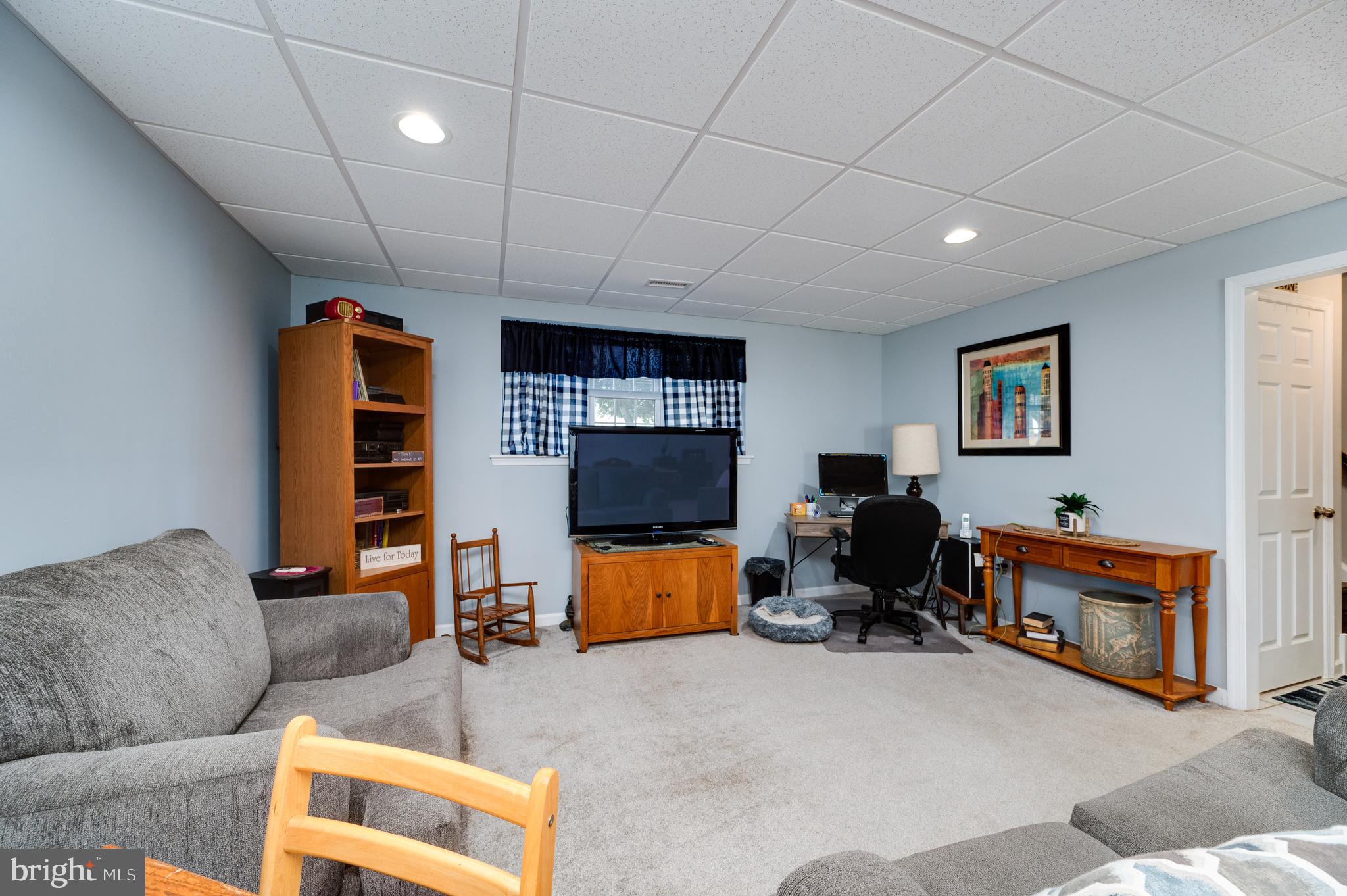 1133 Ashbourne Drive Reading, PA 19605 - Photo 41 of 64 a living room with furniture and a flat screen tv