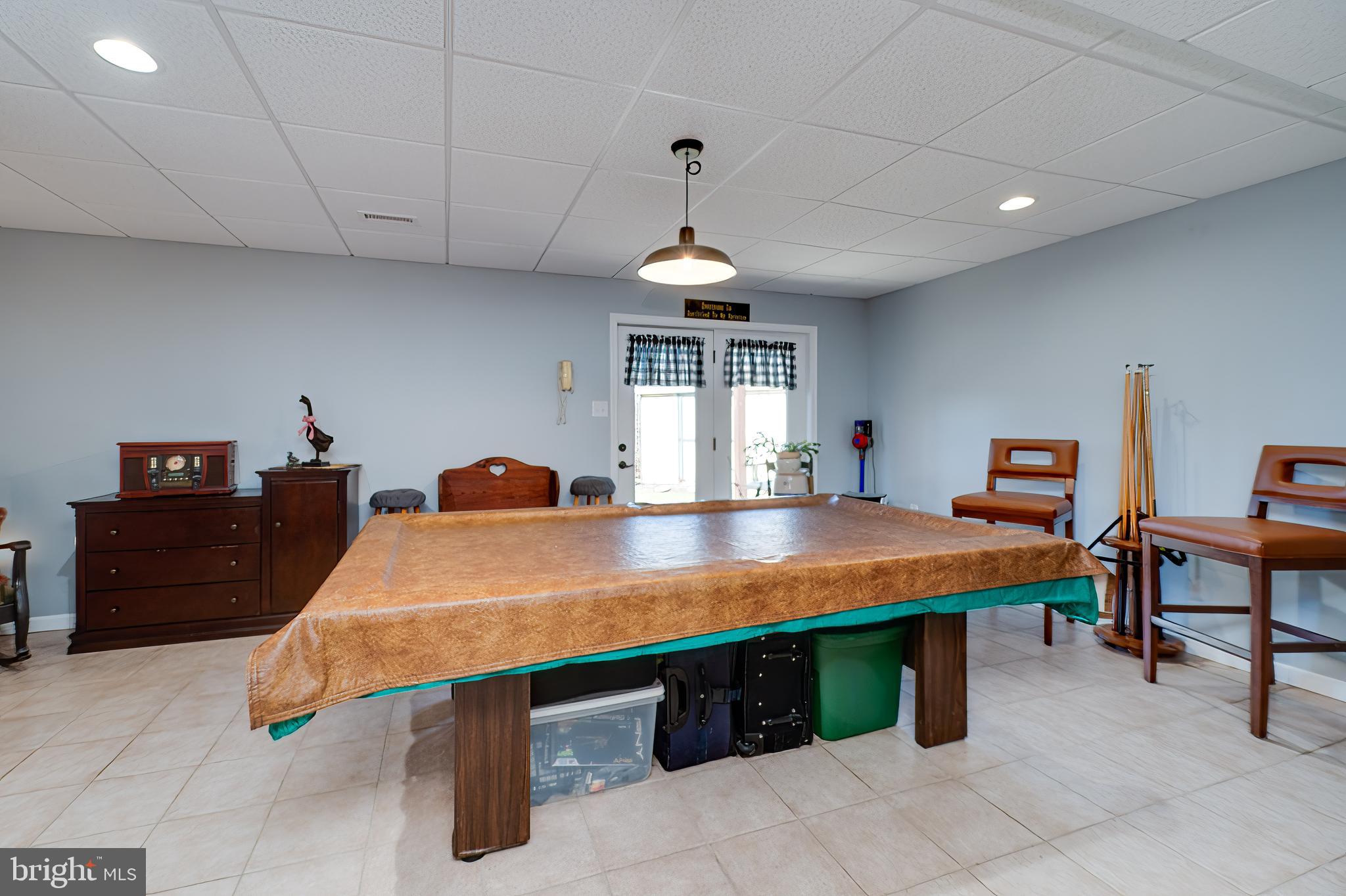 1133 Ashbourne Drive Reading, PA 19605 - Photo 42 of 64 a dining room with a table chairs and ceiling fan