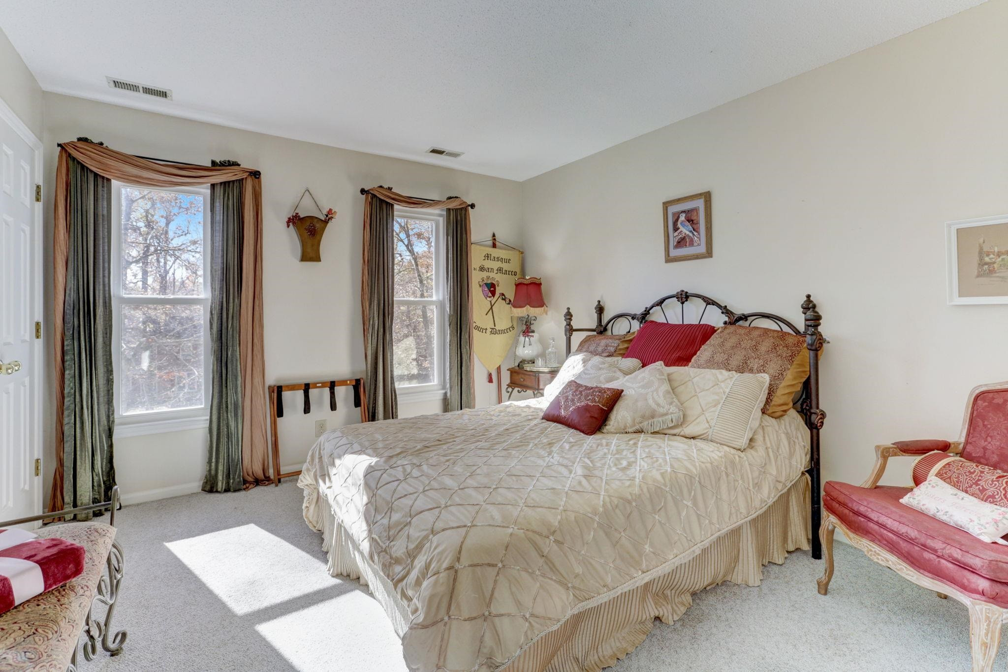 3 Danforth Place Durham, NC 27712 - Photo 23 of 38 a bedroom with a bed and a lamp next to a window