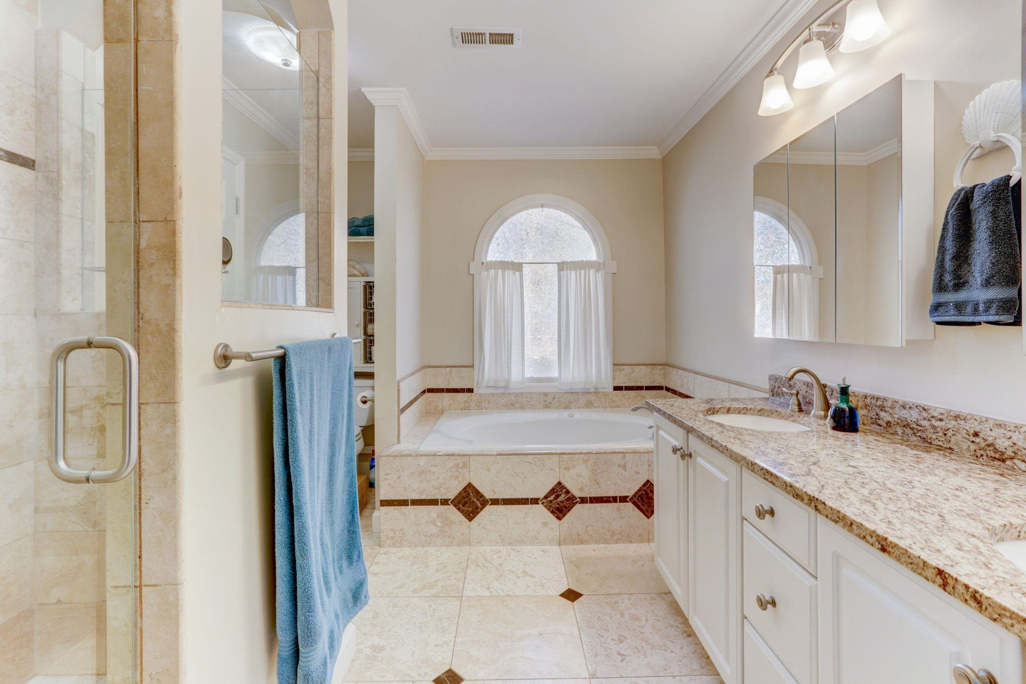 3 Danforth Place Durham, NC 27712 - Photo 25 of 38 a bathroom with a granite countertop sink and a mirror