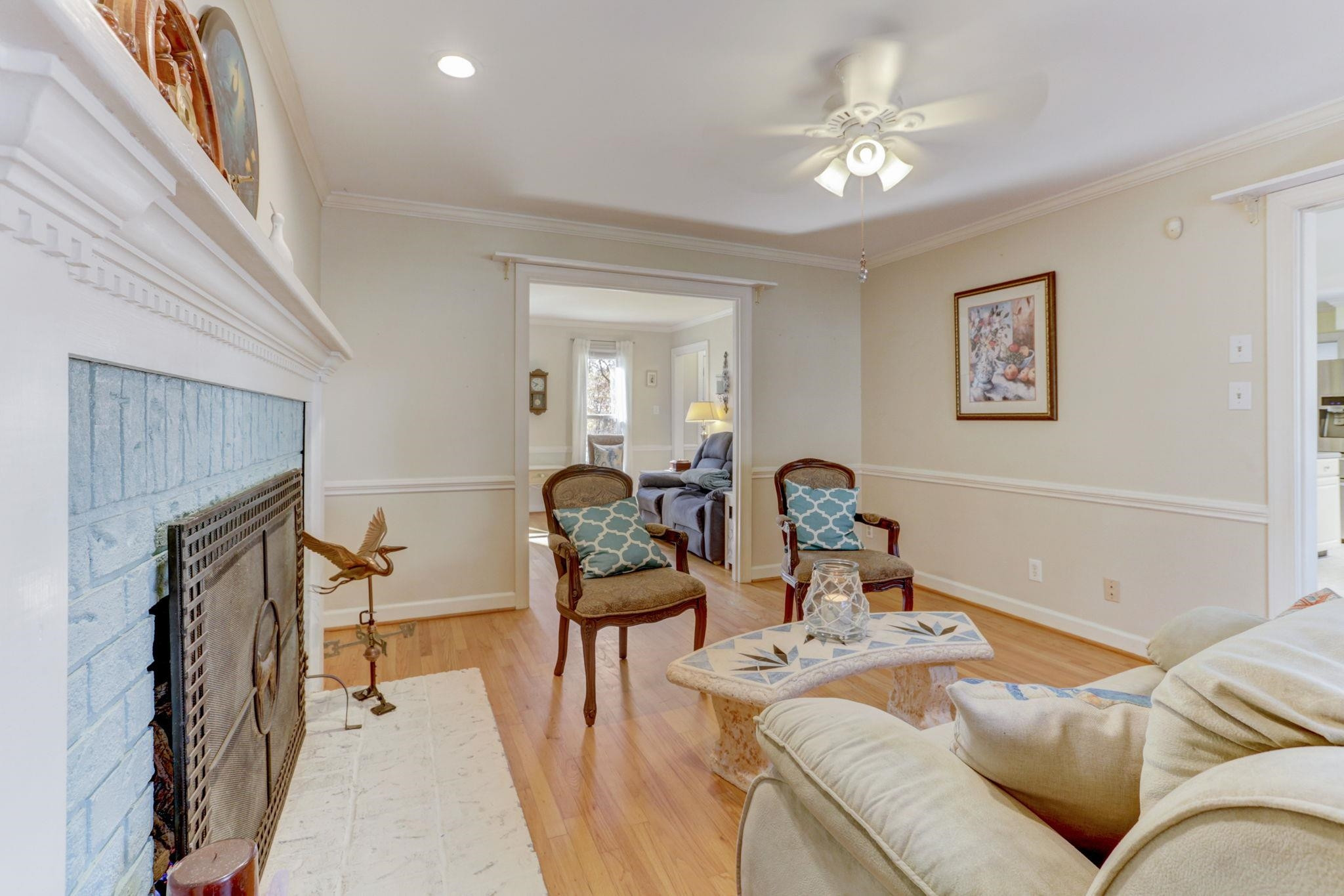 3 Danforth Place Durham, NC 27712 - Photo 10 of 38 a living room with furniture a fireplace and a chandelier