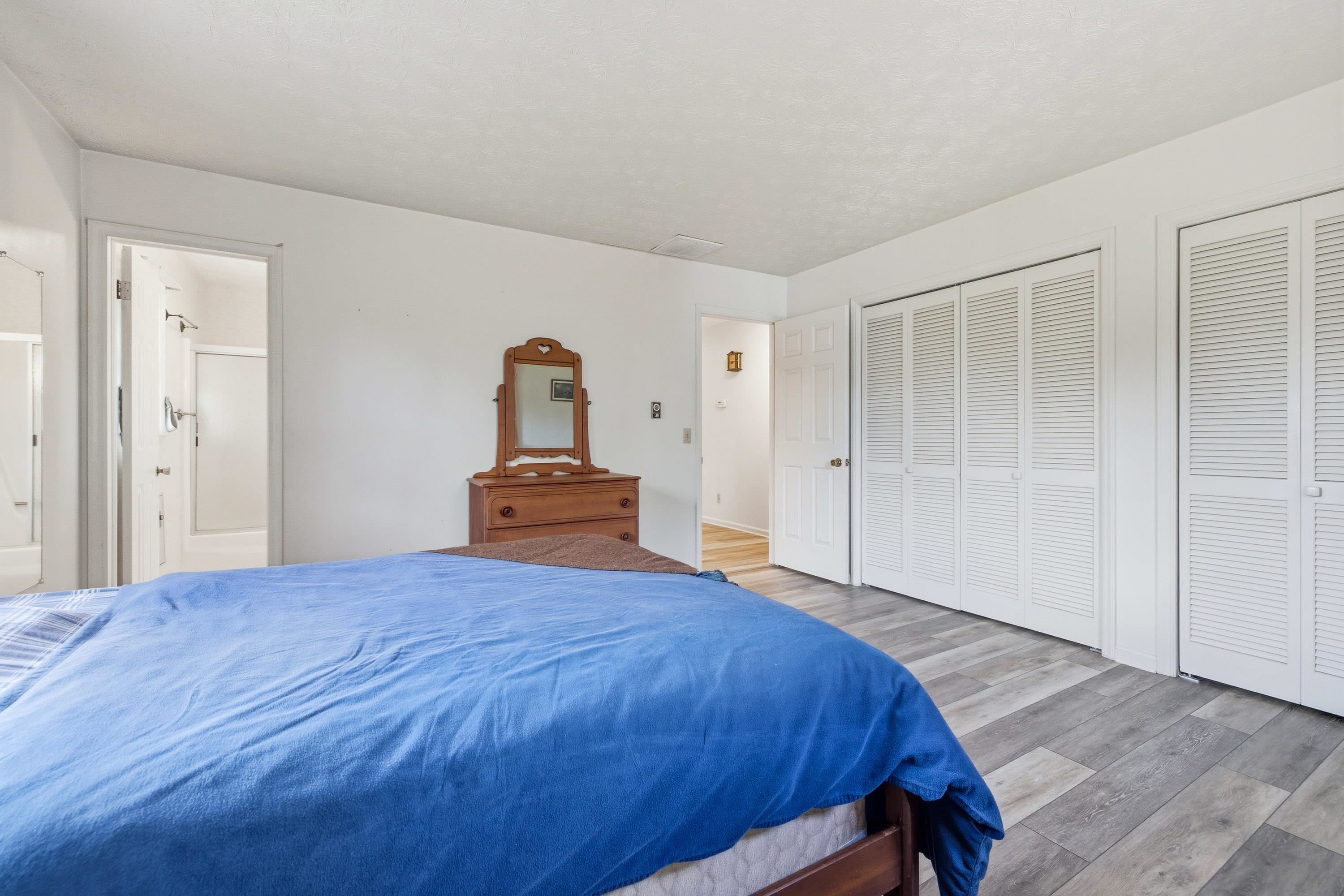 44 Emery Street Harrisonburg, VA 22801 - Photo 22 of 75 The primary bedroom features laminant flooring throughout, large windows, an attached full bathroom, and multiple large closets for storage.