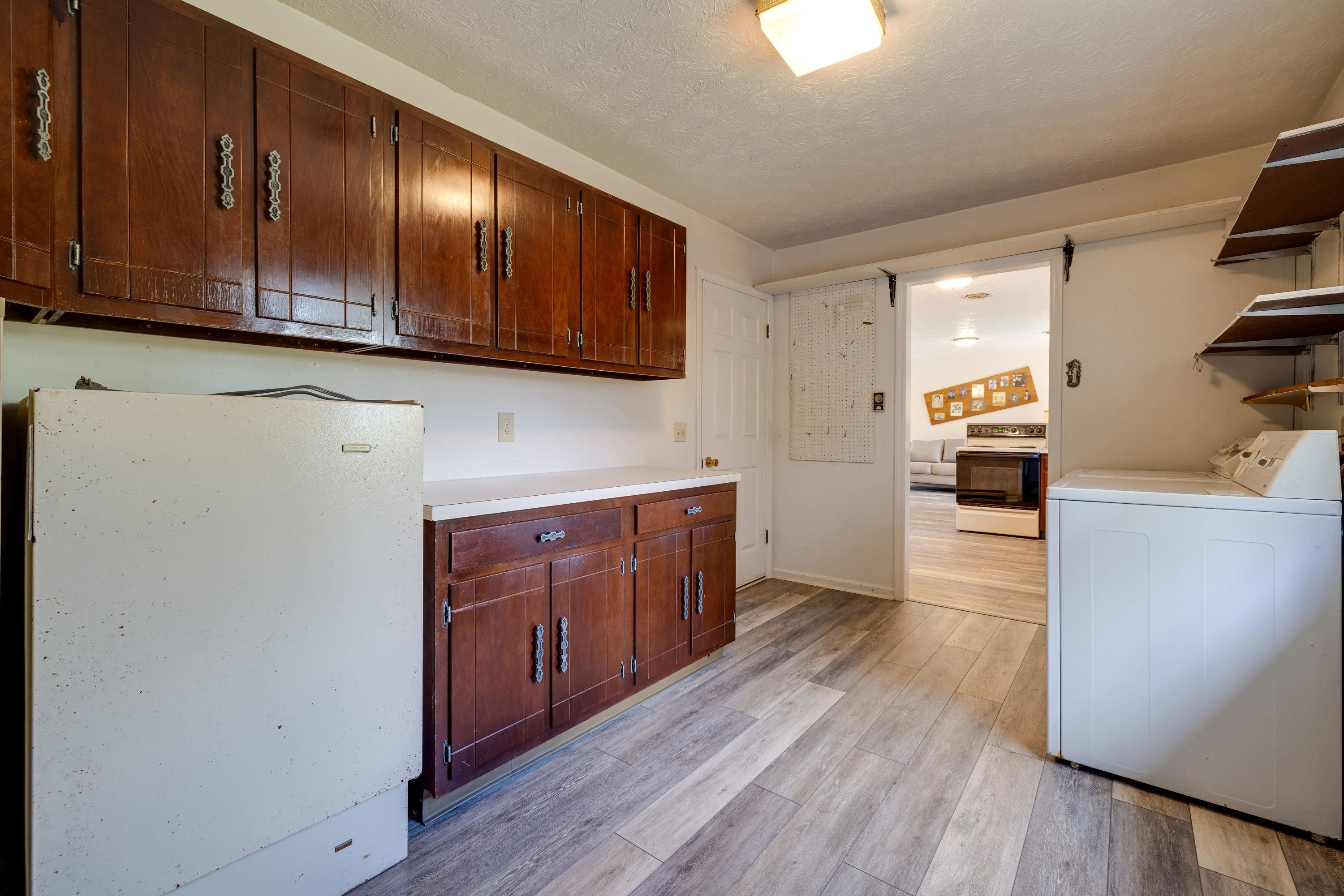 44 Emery Street Harrisonburg, VA 22801 - Photo 44 of 75 a kitchen with stainless steel appliances granite countertop a refrigerator a sink dishwasher and wooden cabinets with wooden floor