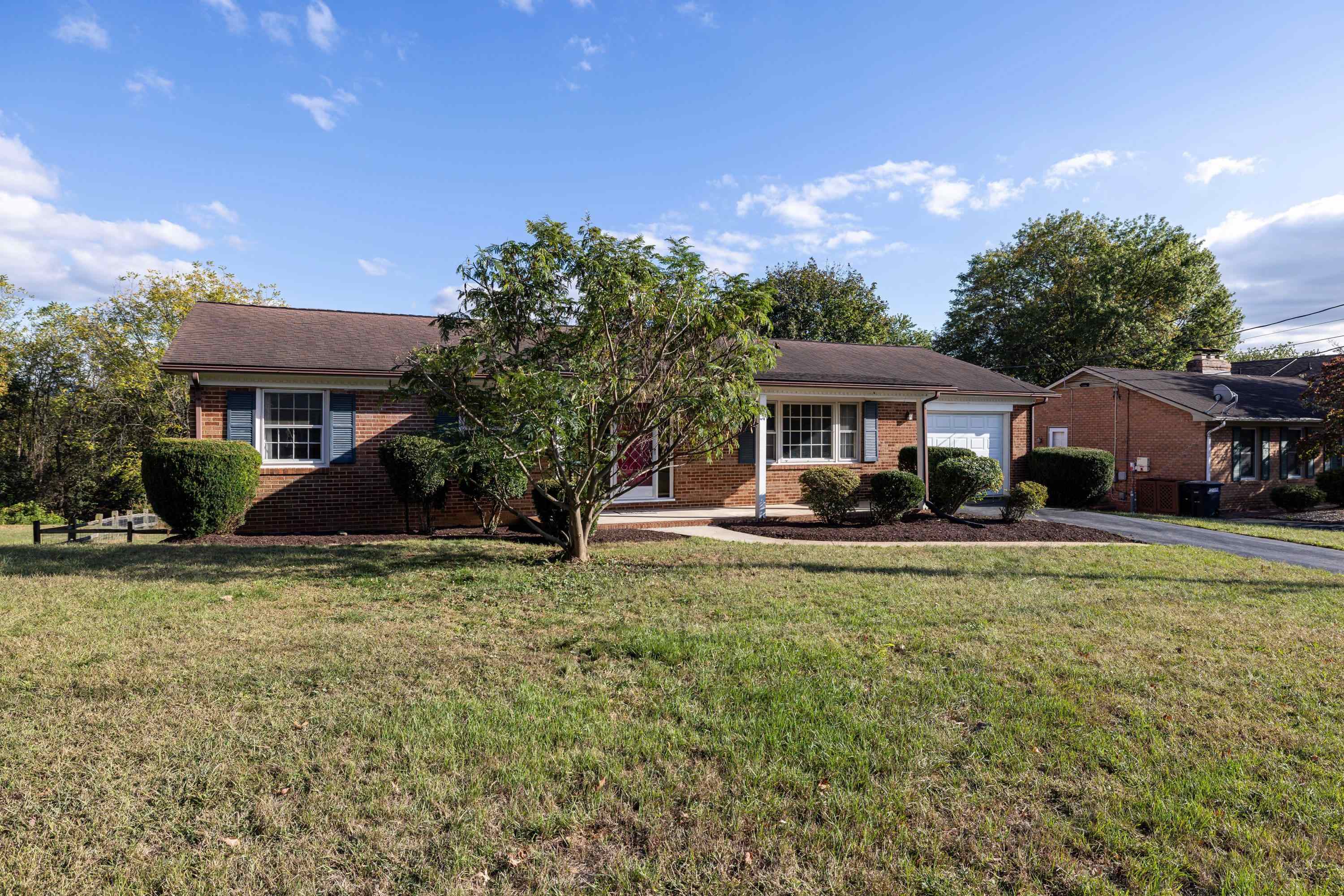 44 Emery Street Harrisonburg, VA 22801 - Photo 49 of 75 The front view of this lovely home highlights the mature landscaping, paved driveway, single-car garage, and spacious front porch.