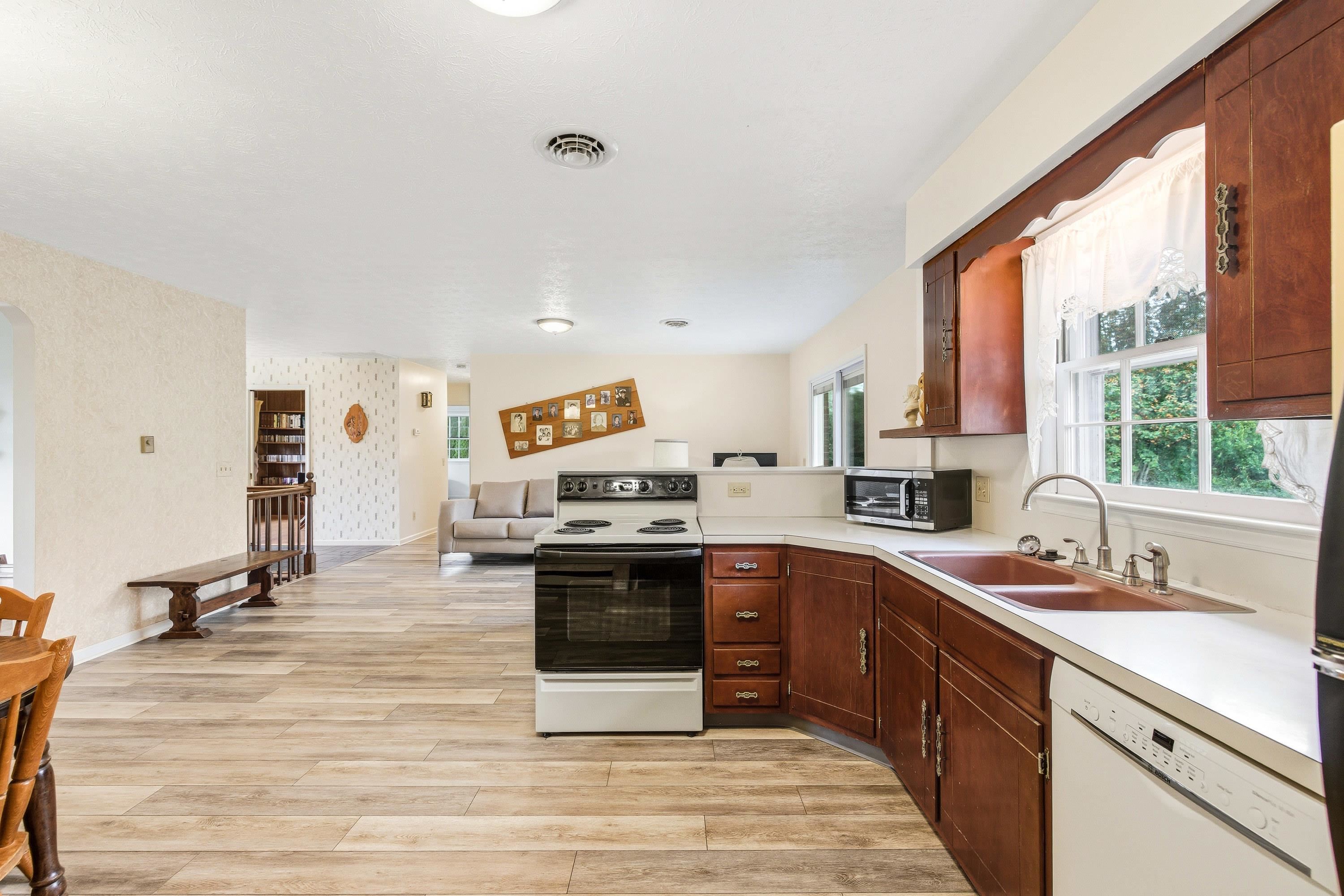 44 Emery Street Harrisonburg, VA 22801 - Photo 5 of 75 a kitchen with stainless steel appliances granite countertop a stove a sink dishwasher and a microwave oven with cabinets
