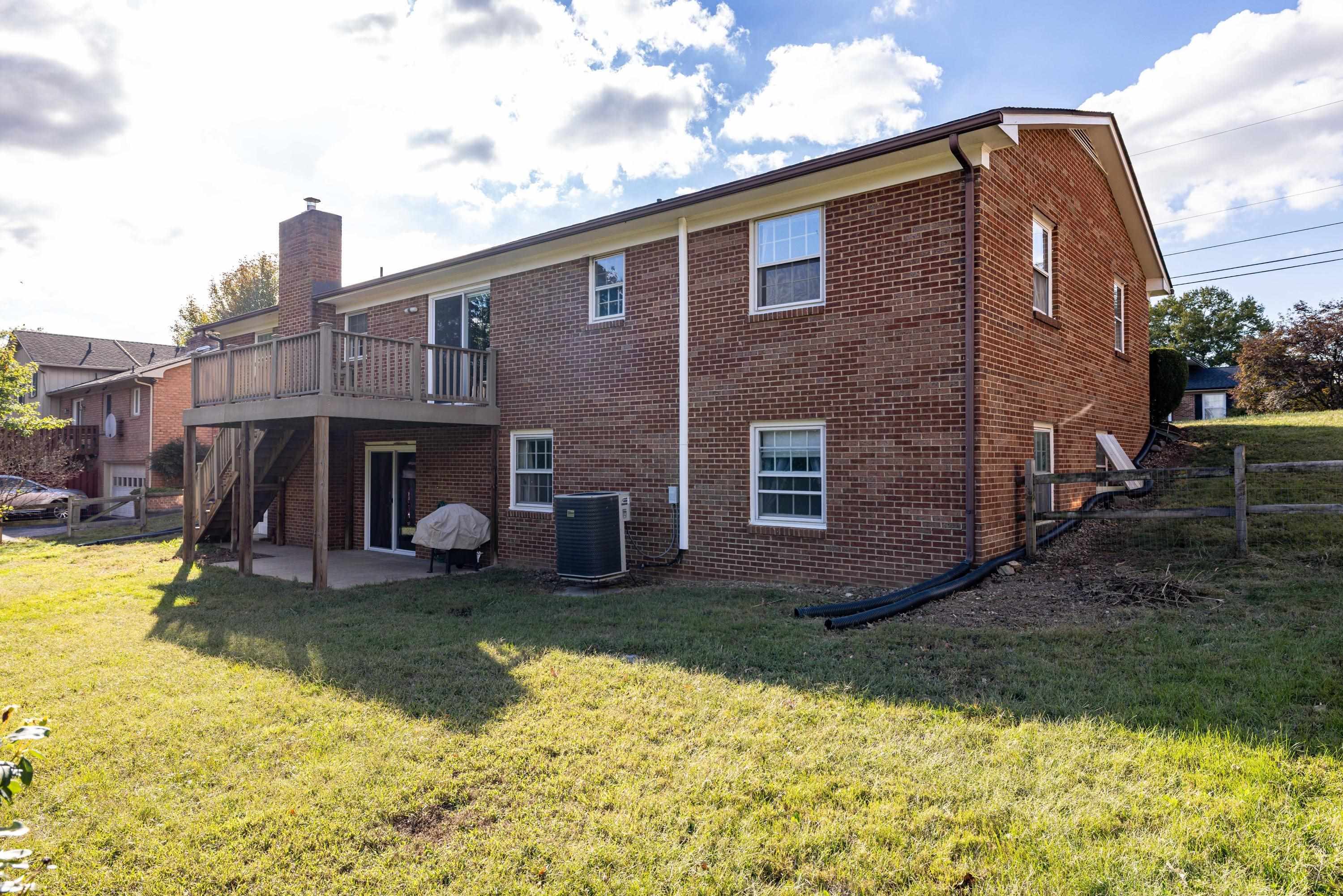 44 Emery Street Harrisonburg, VA 22801 - Photo 62 of 75 The rear view of the home highlights the large deck off the rear of the home, covered patio area, and spacious back yard that is fully fenced.