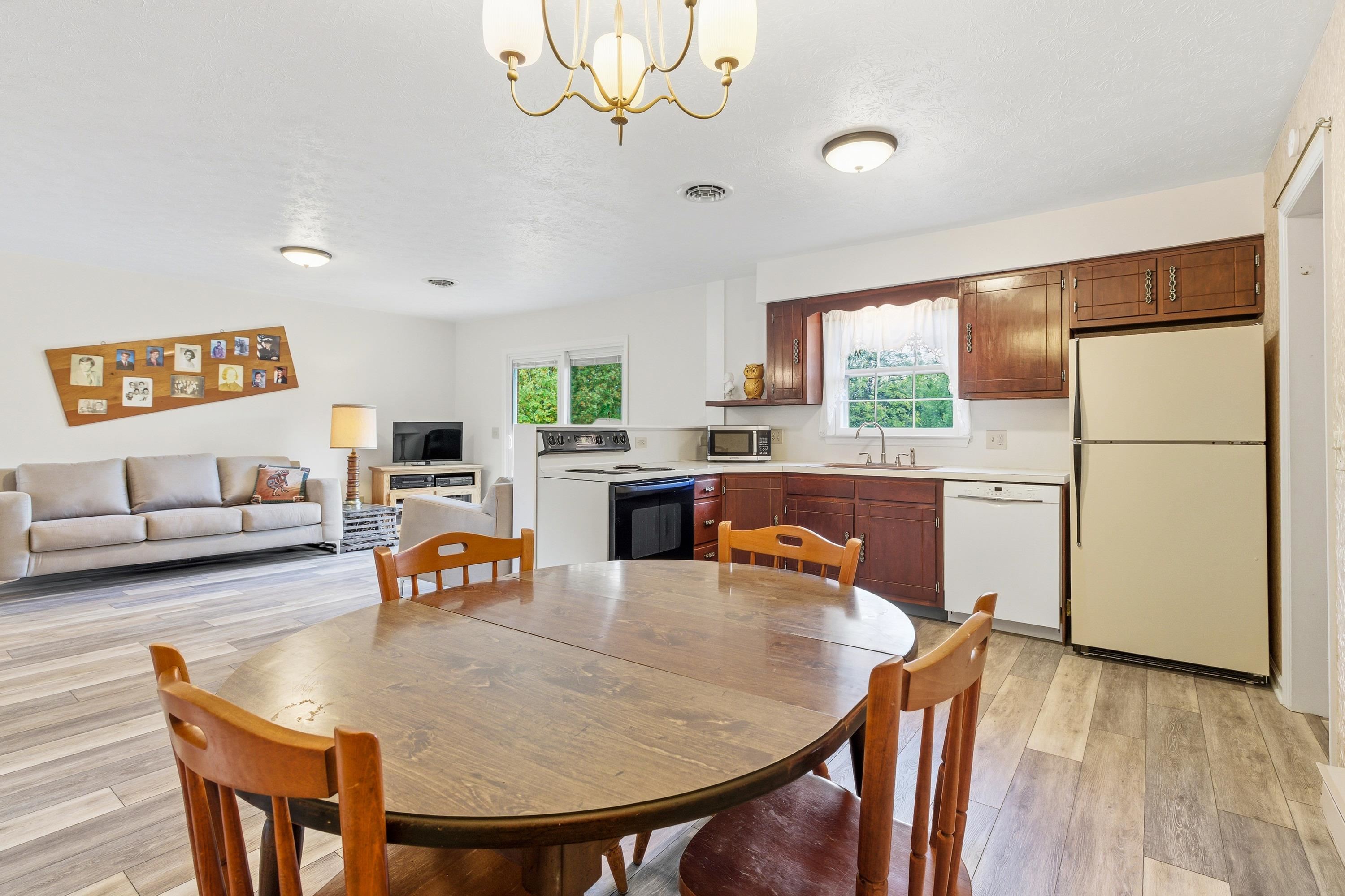 44 Emery Street Harrisonburg, VA 22801 - Photo 9 of 75 a kitchen with stainless steel appliances granite countertop a dining table chairs refrigerator and sink
