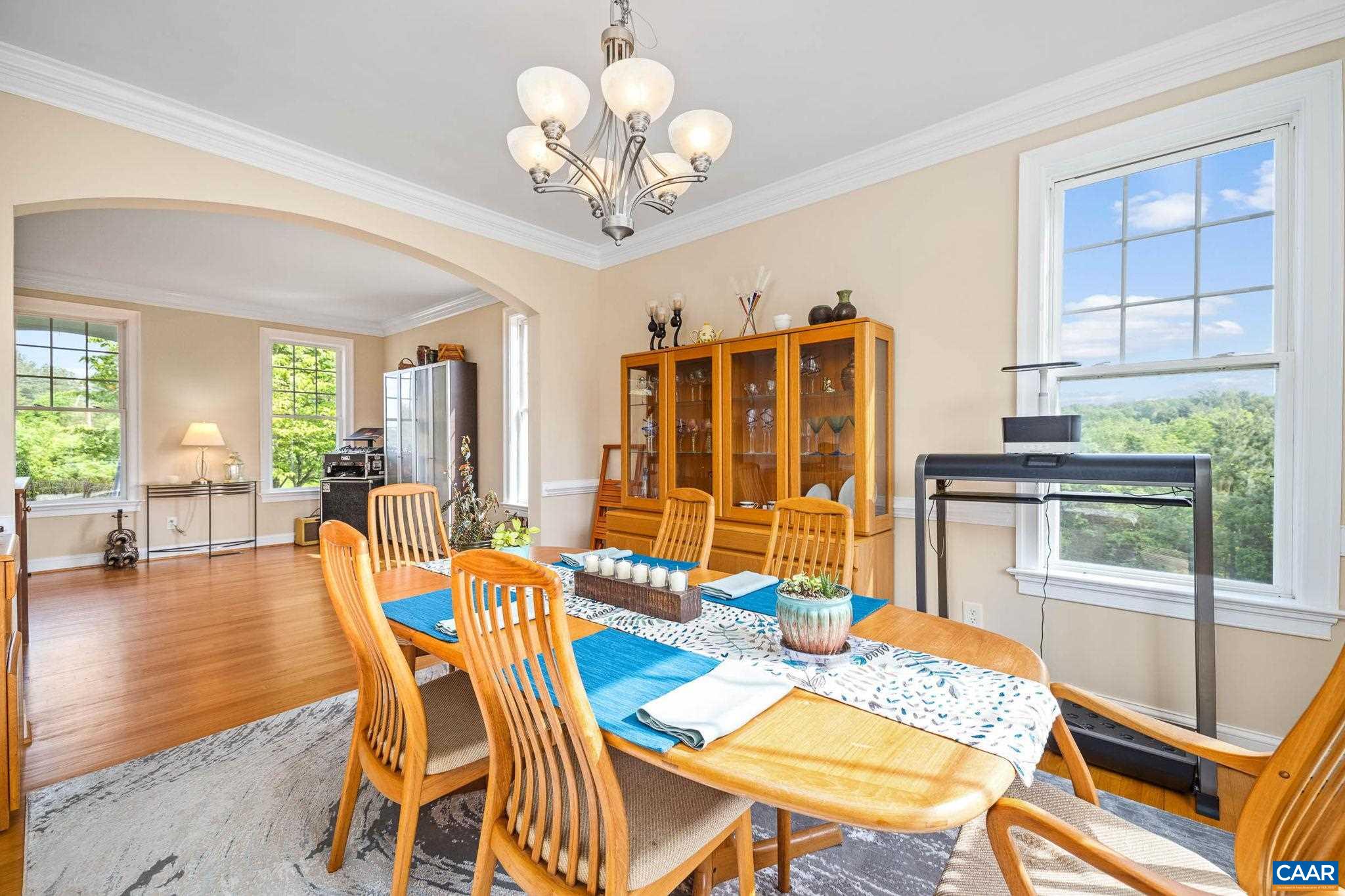 4271 Stony Point Road Keswick, VA 22947 - Photo 11 of 68 a view of a dining room with furniture a chandelier and wooden floor