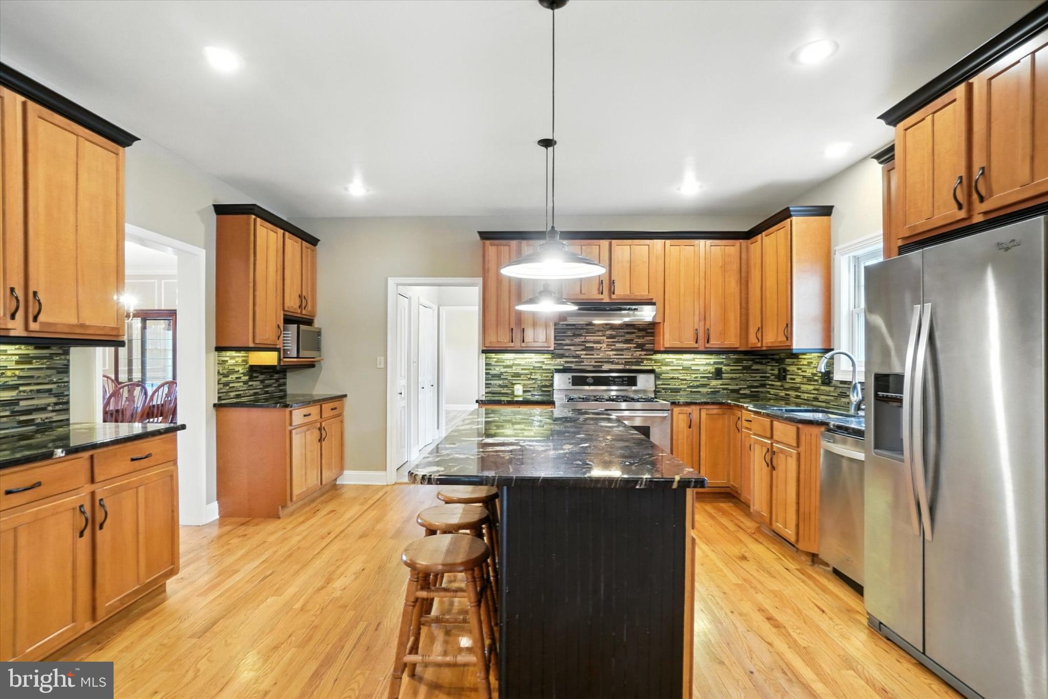 160 Vida Lane Dover, PA 17315 - Photo 13 of 61 a kitchen with stainless steel appliances granite countertop a refrigerator a stove top oven a sink dishwasher and wooden cabinets with wooden floor