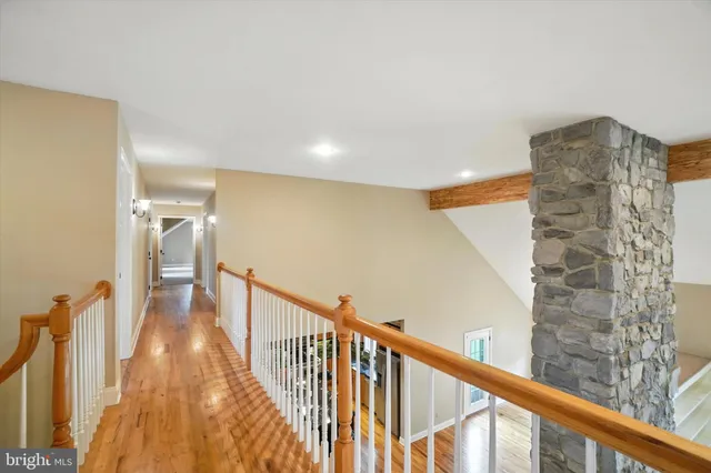 a spacious bedroom with a large bed and a chandelier