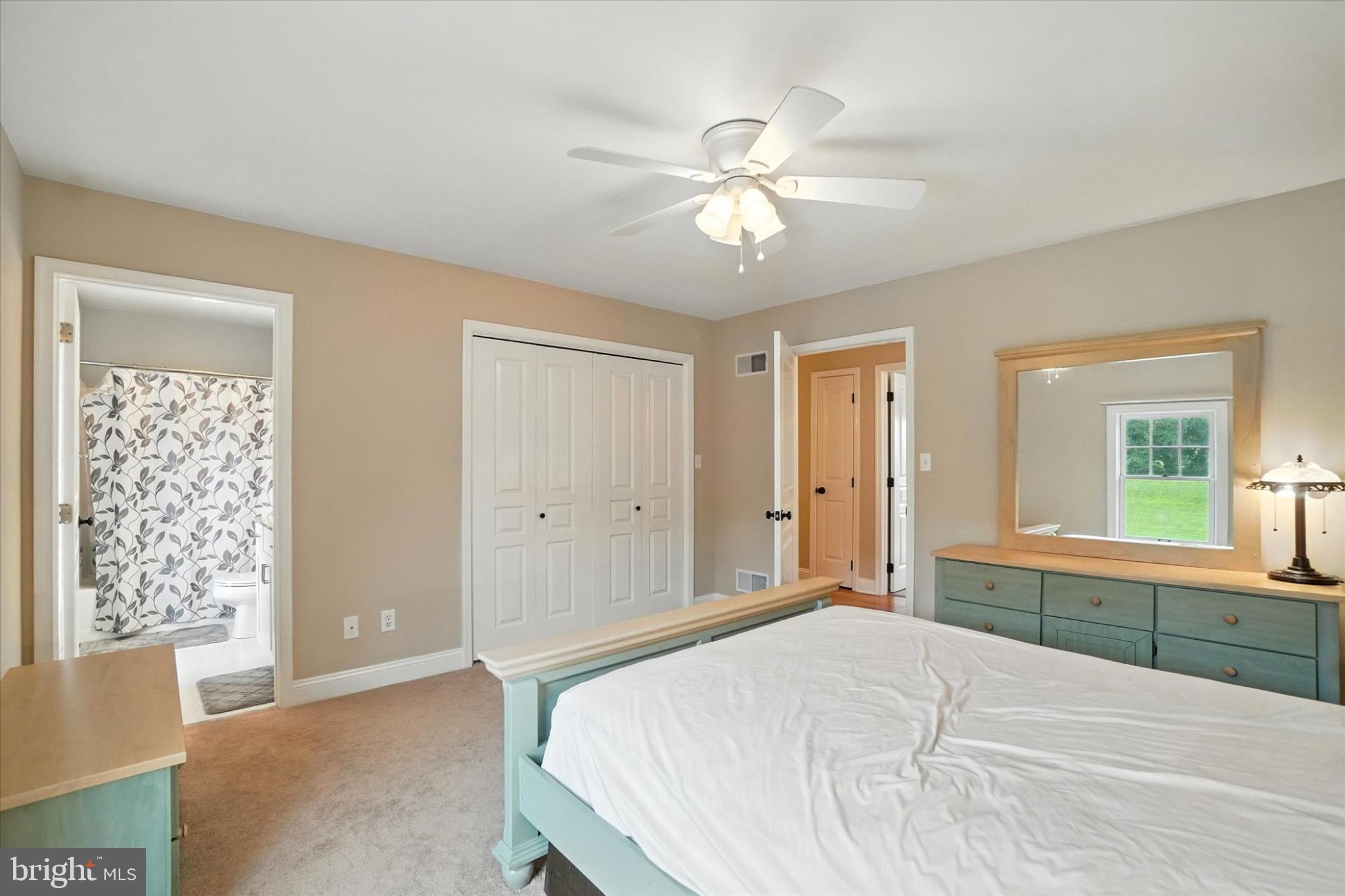 160 Vida Lane Dover, PA 17315 - Photo 32 of 61 a spacious bedroom with a large bed and a chandelier