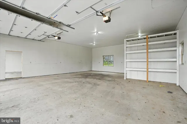 a view of a house with a yard and potted plants