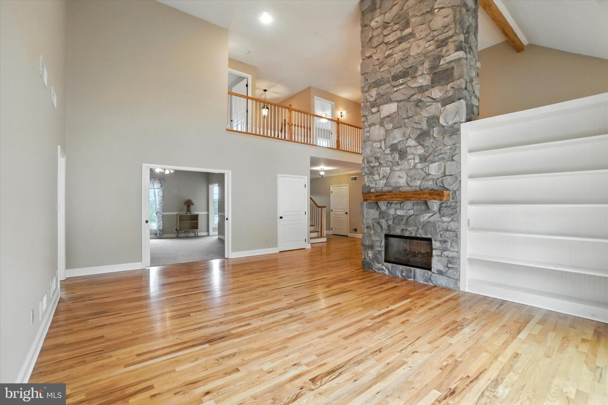 160 Vida Lane Dover, PA 17315 - Photo 7 of 61 a view of empty room with fireplace and wooden floor